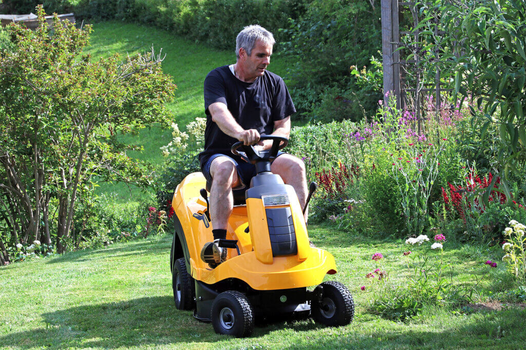  Man on ride-on lawn mower