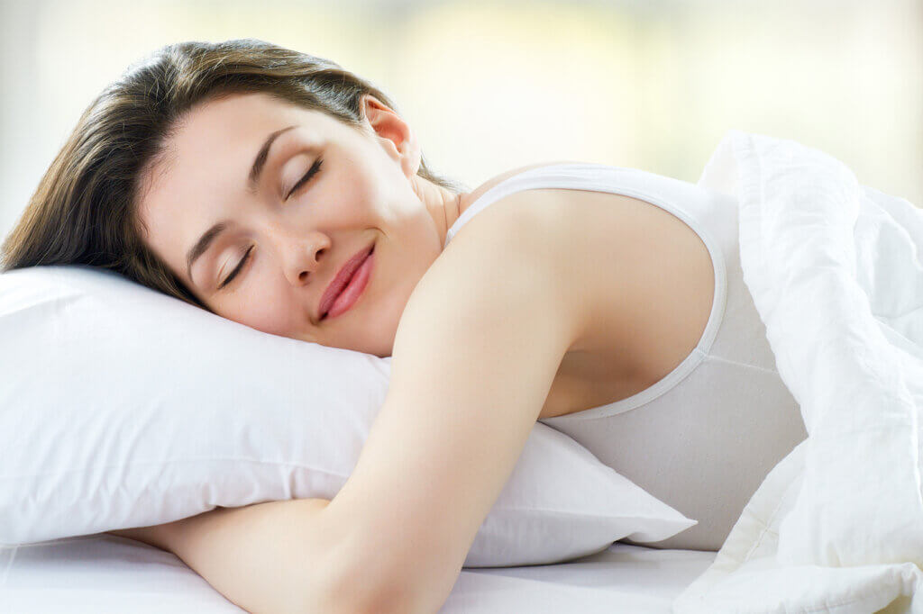 Woman lying in bed Gel foam mattress topper