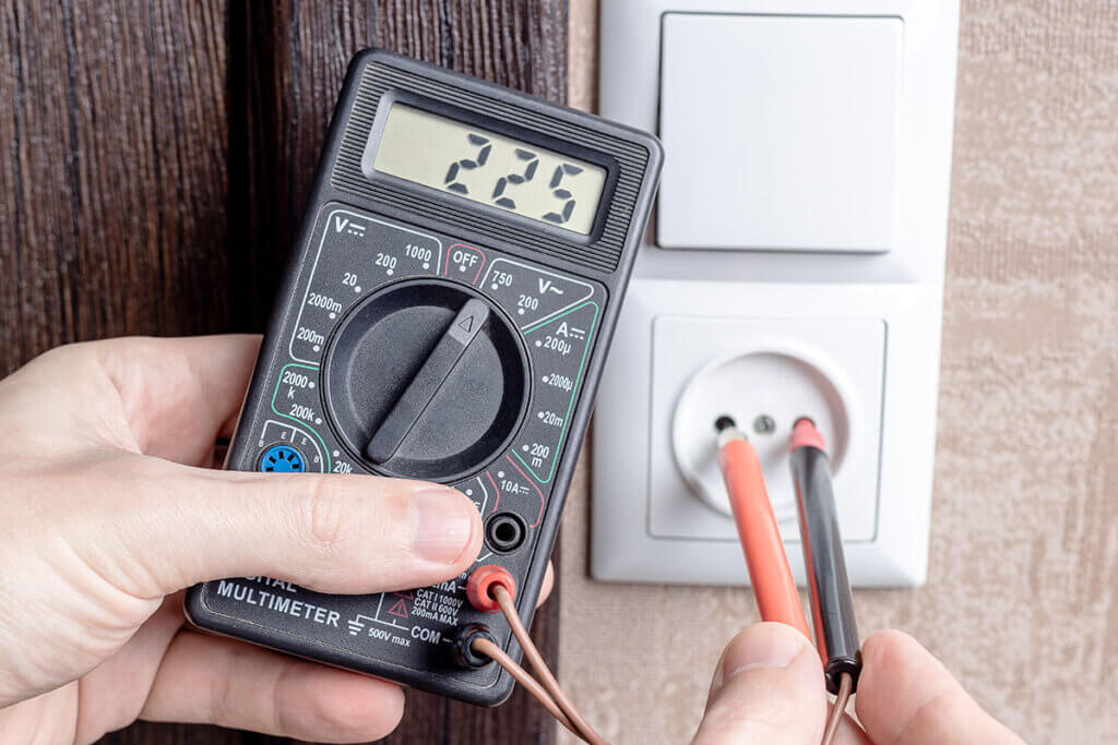 Multimeter Checking a Power Socket