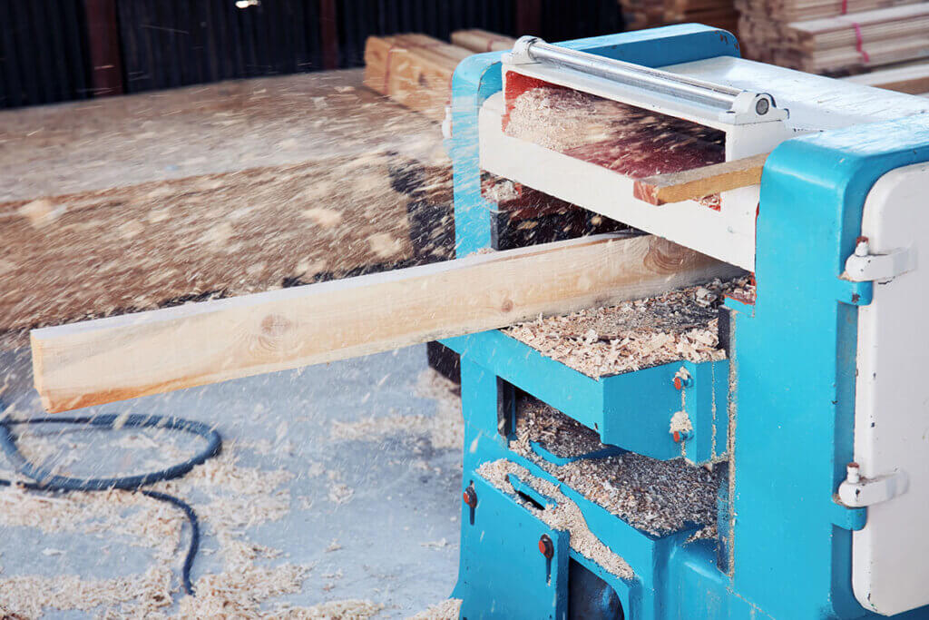 Wood is planed by large stationary planer