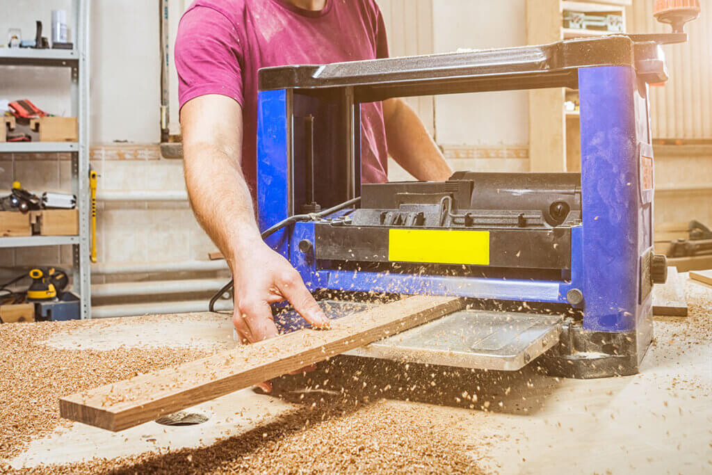 Wooden board is planed with a planer