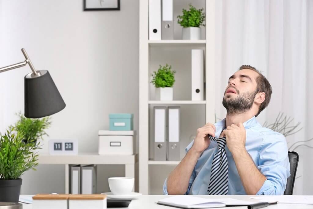Man sitting in the office sweating