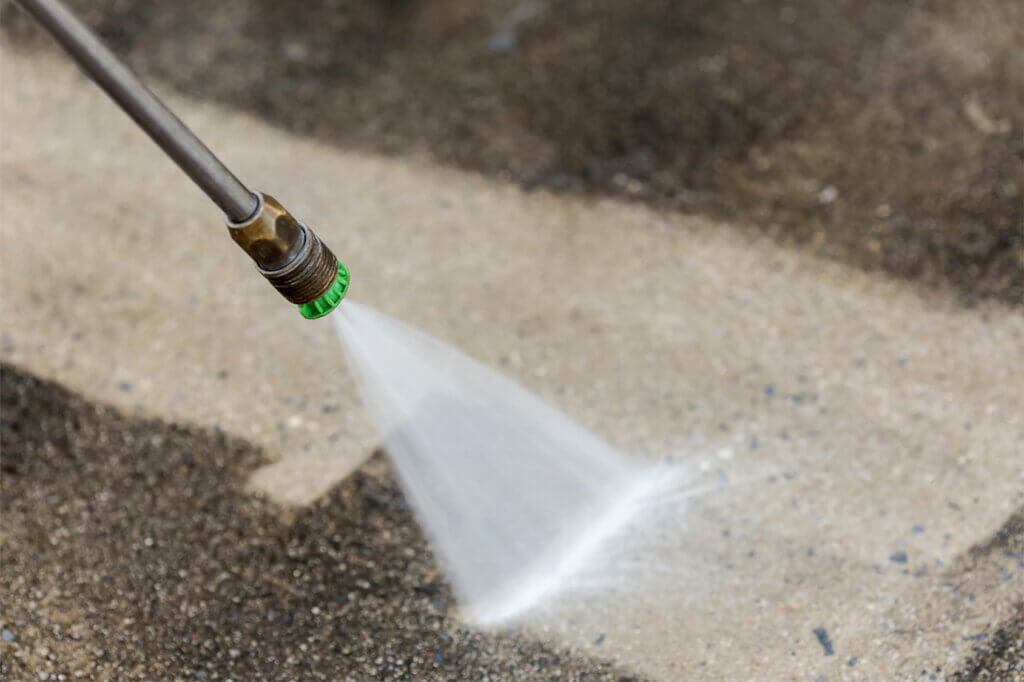 pressure washer cleans the floor from dirt