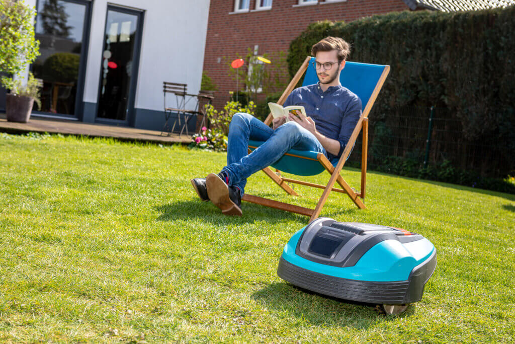  Robot mower and man in the garden chair