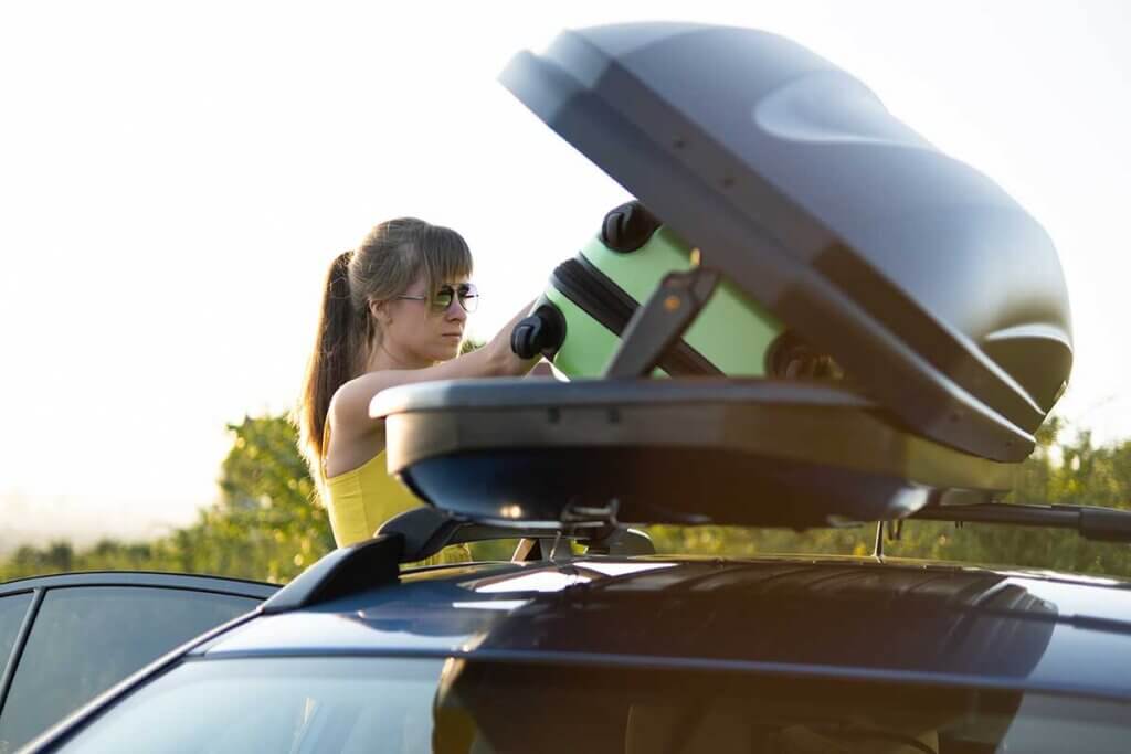 Woman loading roof box