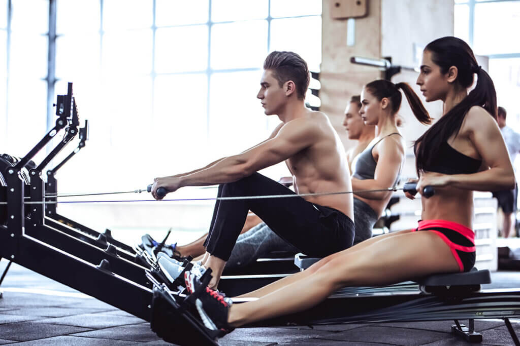 women and men on the rowing gear