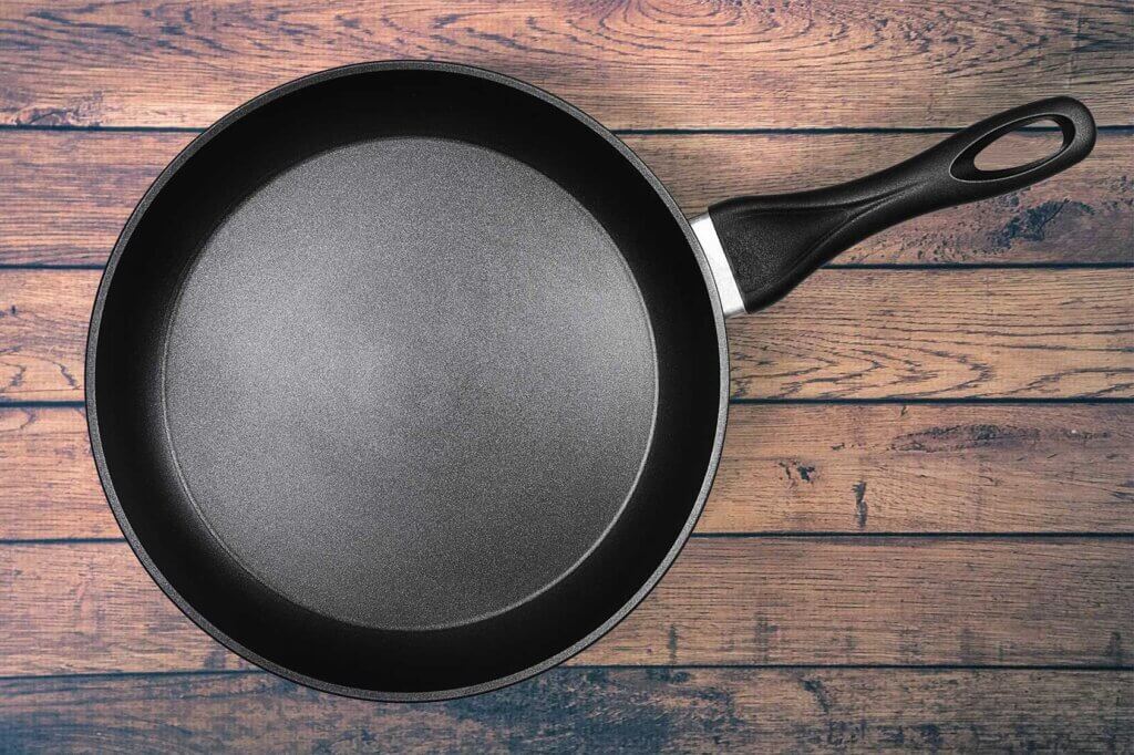 aluminum skillet on wooden table