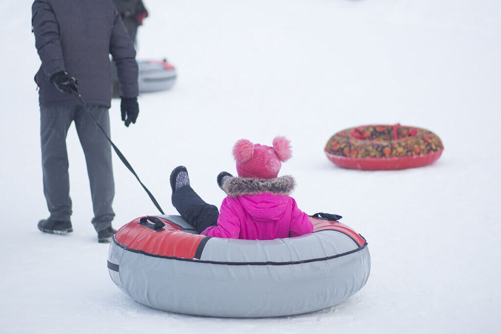 child on inflatable sled