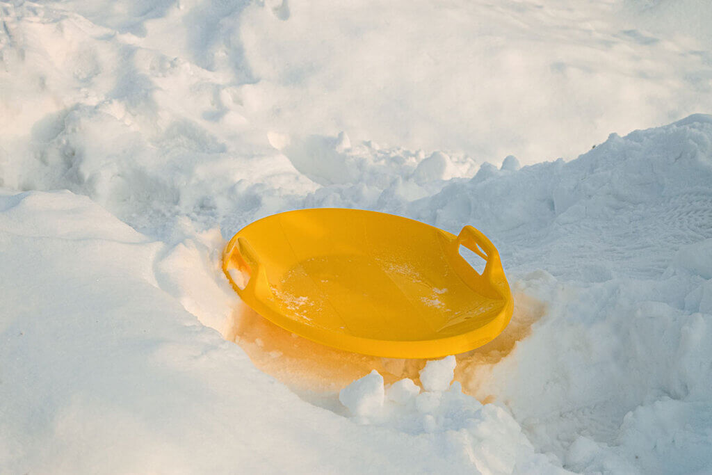 yellow saucer on snow