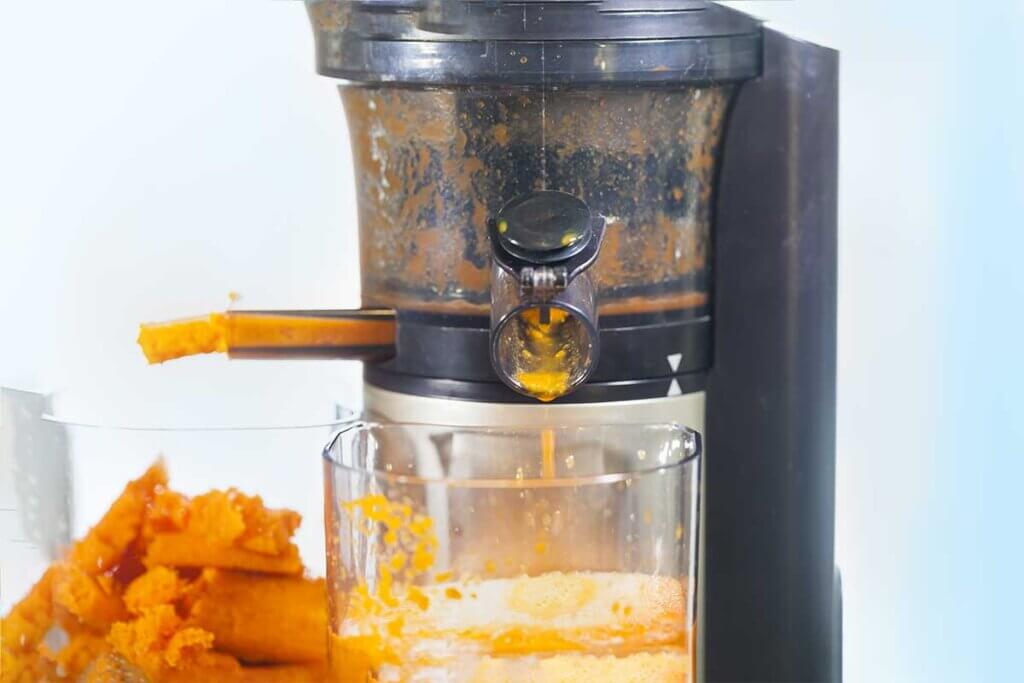 slow juicer juicing carrots