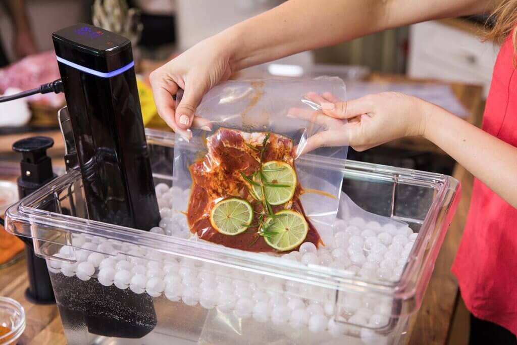 Woman cooking meat sous-vide