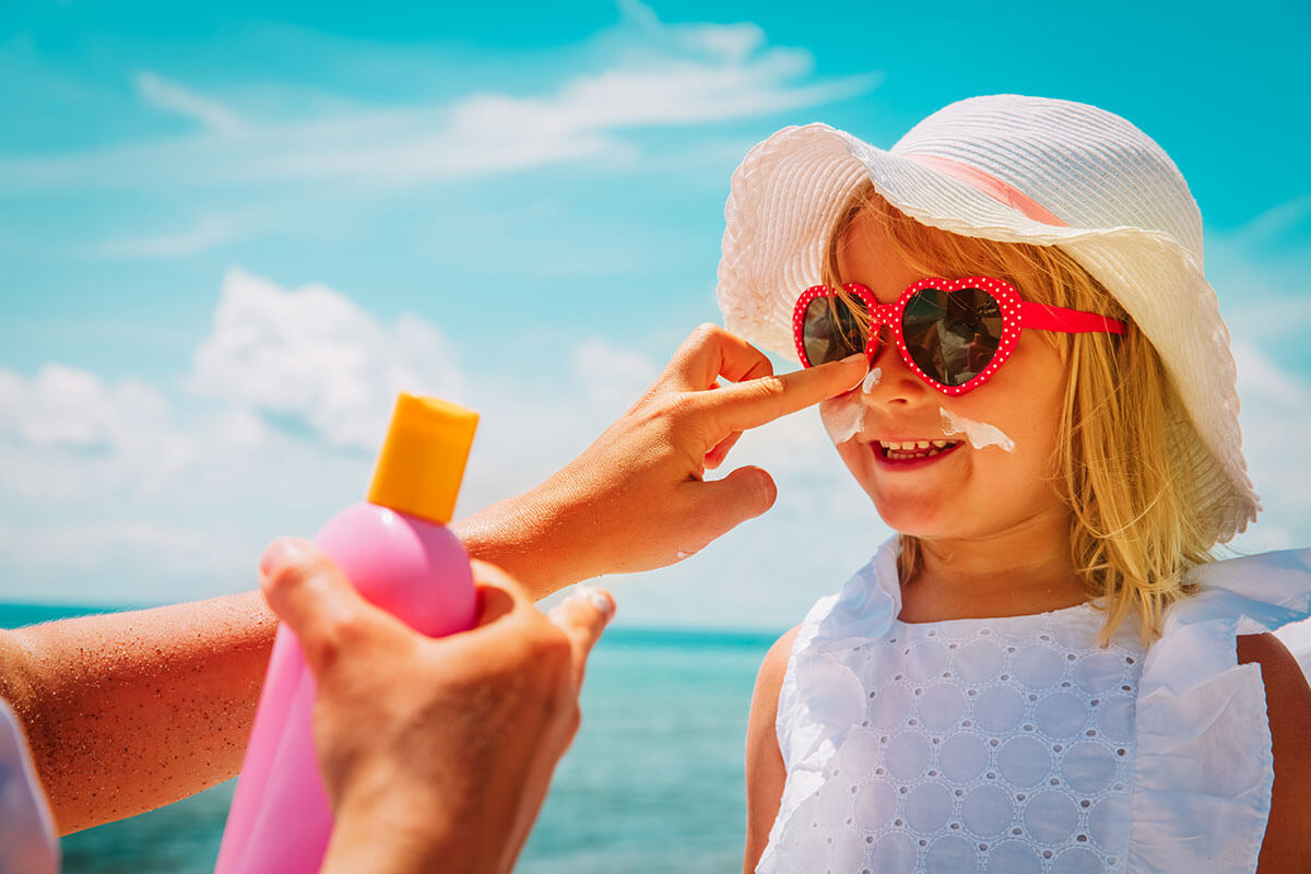 parents apply cream to child