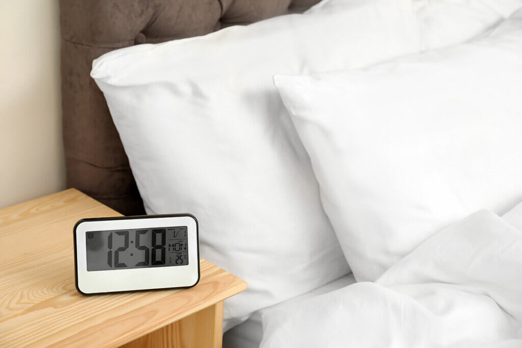 Alarm clock on bedside table