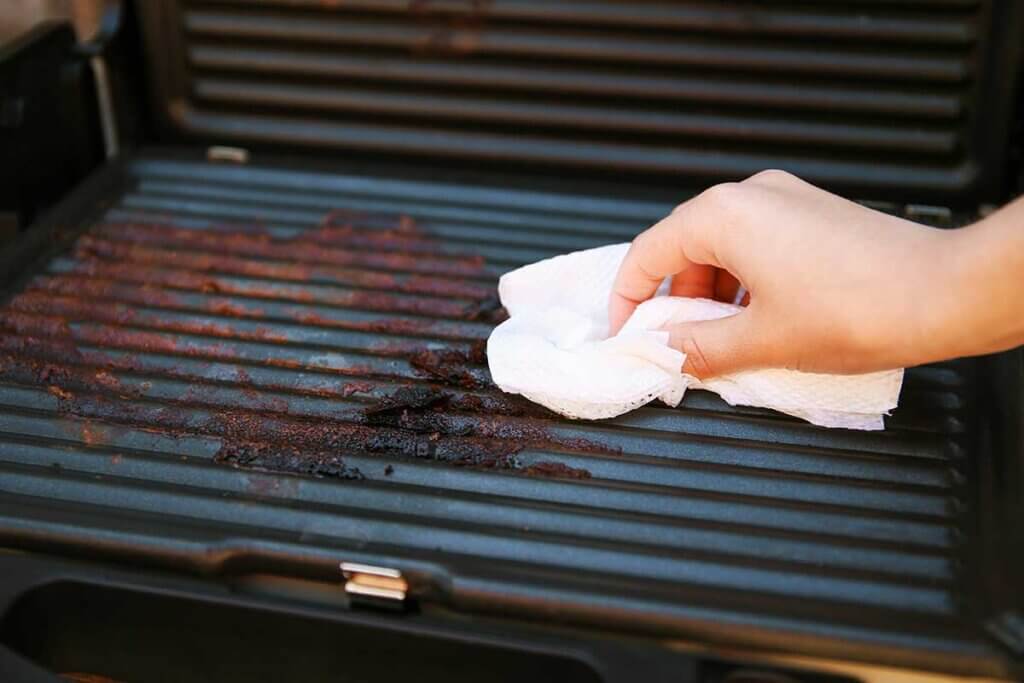 dirty e-grill is being cleaned