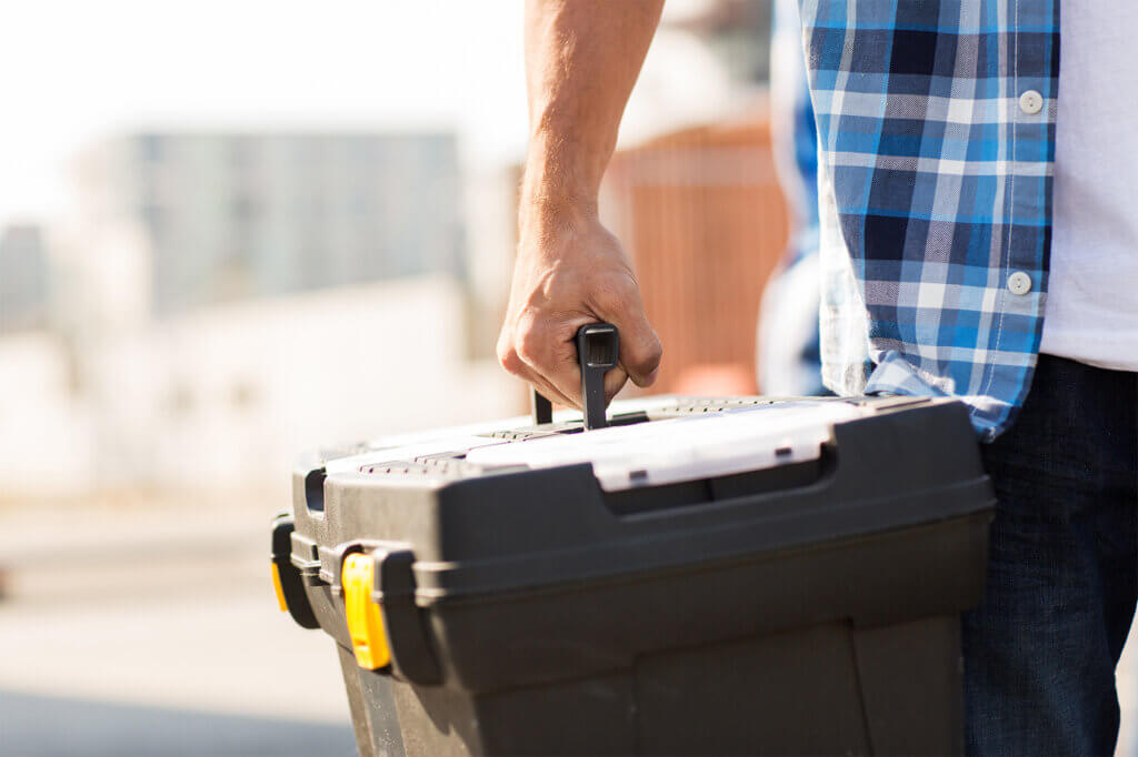 man carries toolbox