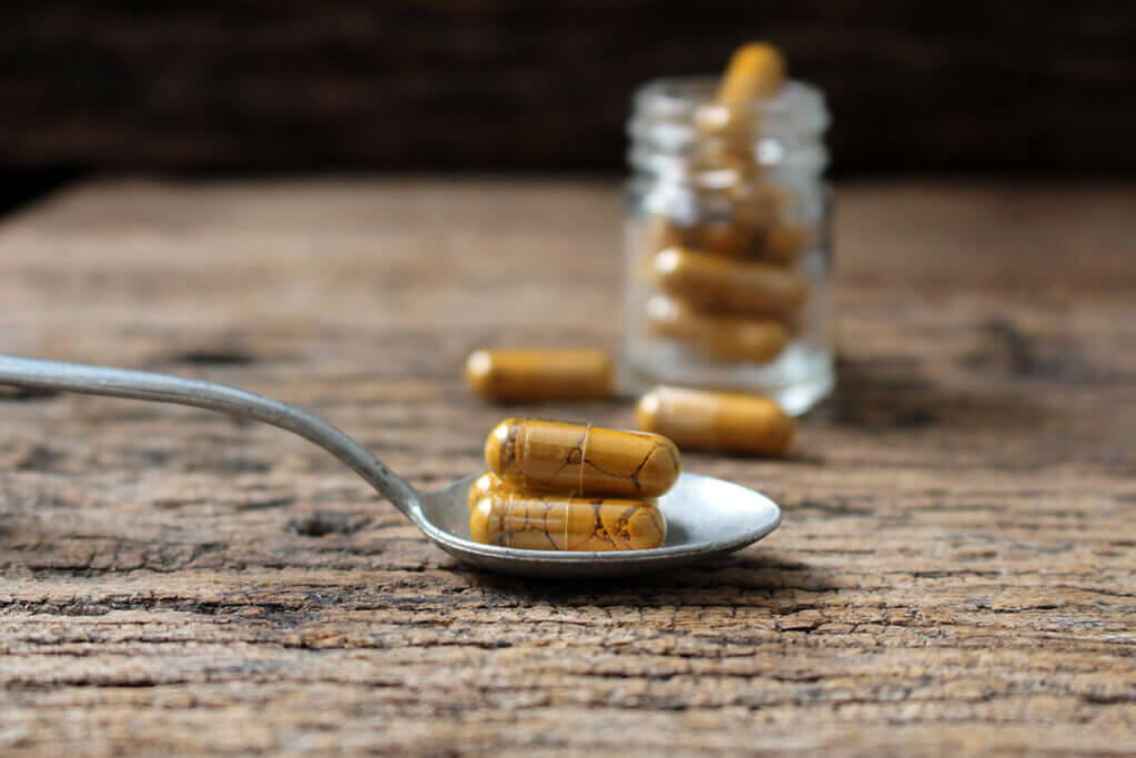 turmeric capsules on a spoon