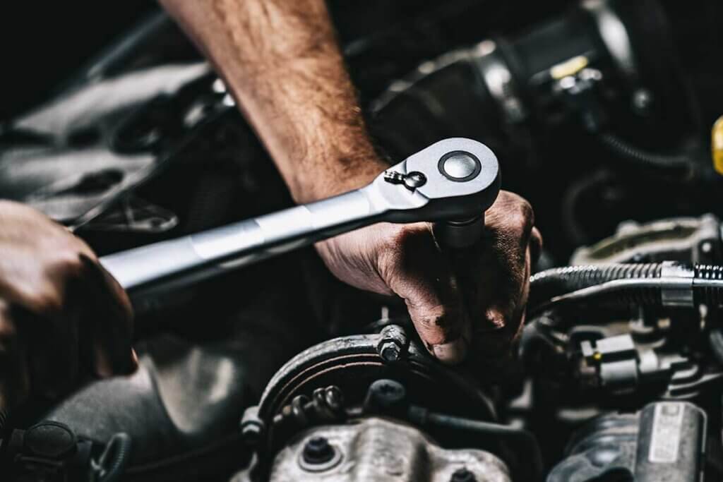 man repairs engine