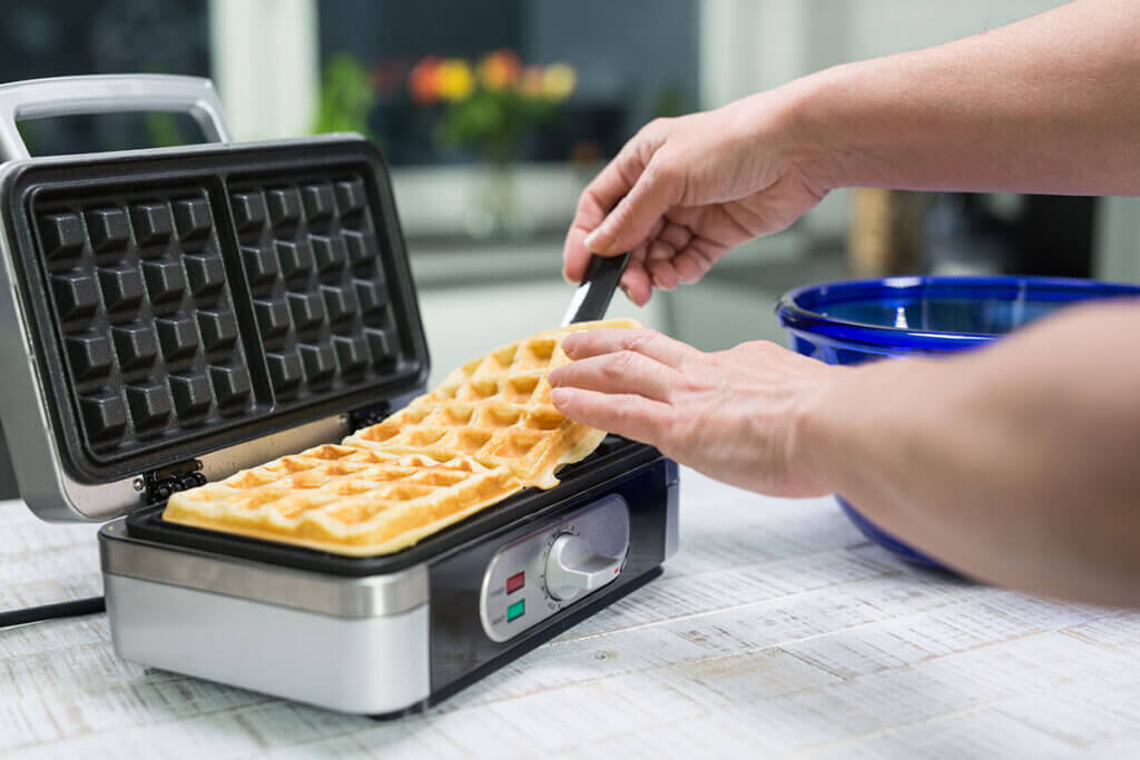 Finished waffle is removed from waffle iron