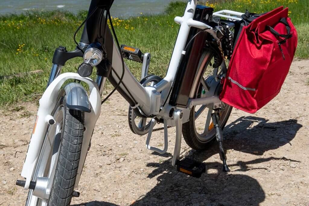 white_folding_e_bike_in_front_of_river