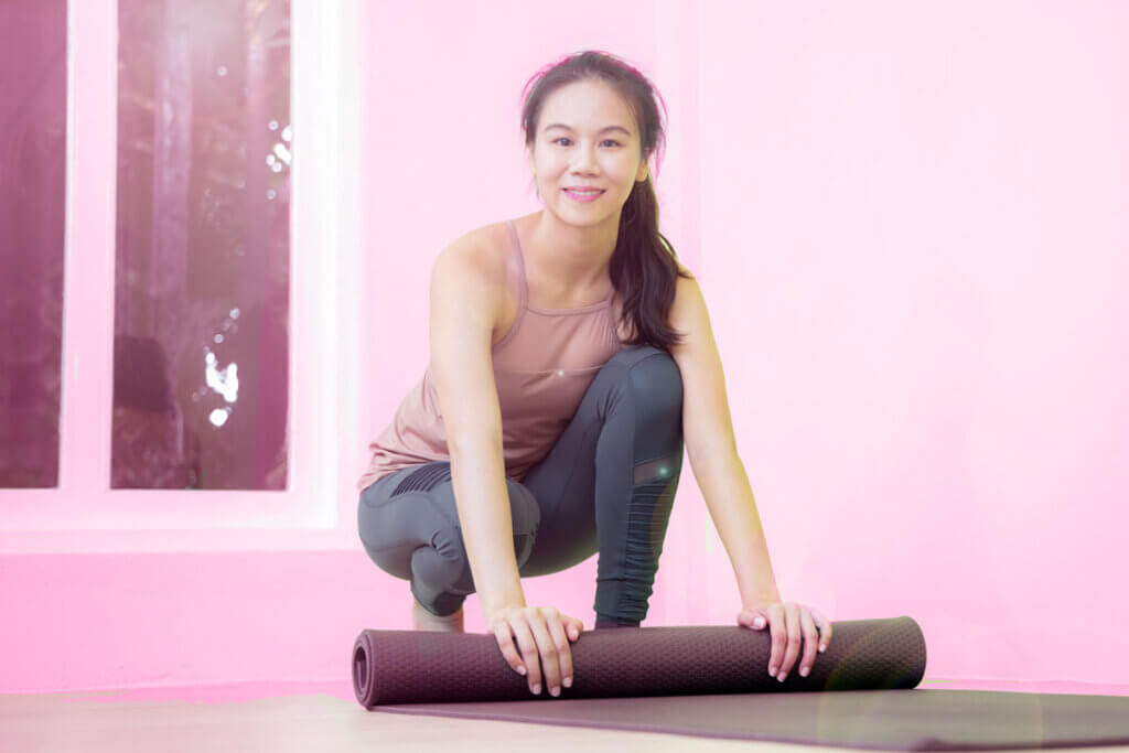 woman rolling out mat